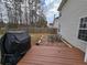 Backyard featuring a wooden deck, stone patio with outdoor seating, and a grill for relaxing and dining at 9620 Carolina Dr, Jonesboro, GA 30238