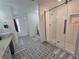 Modern bathroom featuring patterned tile floors, a glass-enclosed shower, and a freestanding tub at 9620 Carolina Dr, Jonesboro, GA 30238