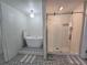 Bathroom showcasing a modern soaking tub and a glass-enclosed shower with decorative tile at 9620 Carolina Dr, Jonesboro, GA 30238