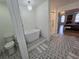 Bathroom showing a soaking tub, glass enclosed shower, toilet and decorative tile flooring at 9620 Carolina Dr, Jonesboro, GA 30238