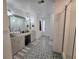 Bright bathroom features double vanity sinks, decorative tile flooring, and a glass-enclosed shower at 9620 Carolina Dr, Jonesboro, GA 30238