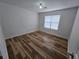 This bedroom has clean white walls, hardwood floors, and a window with decorative blinds at 9620 Carolina Dr, Jonesboro, GA 30238