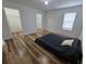 This bedroom features wood floors, a closet, and a window for natural light at 9620 Carolina Dr, Jonesboro, GA 30238