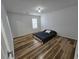 Bedroom with wood flooring features a bed and a large window for natural light at 9620 Carolina Dr, Jonesboro, GA 30238