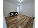 This bedroom features wood floors, a window, and white walls at 9620 Carolina Dr, Jonesboro, GA 30238