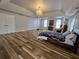 Expansive bedroom featuring hardwood floors, a chandelier, and large windows for natural light at 9620 Carolina Dr, Jonesboro, GA 30238