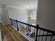 View of the foyer from the second floor with hardwood floors and decorative chandelier at 9620 Carolina Dr, Jonesboro, GA 30238