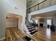 Inviting foyer with hardwood floors, staircase, and view into the formal living room with fireplace at 9620 Carolina Dr, Jonesboro, GA 30238