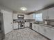 Modern kitchen with stainless steel appliances, white cabinets, and tile backsplash at 9620 Carolina Dr, Jonesboro, GA 30238