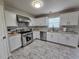 Renovated kitchen featuring stainless steel appliances, decorative tile backsplash and tile floor at 9620 Carolina Dr, Jonesboro, GA 30238