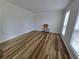 This living room has wood floors, white walls, and a large window at 9620 Carolina Dr, Jonesboro, GA 30238