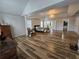 Spacious primary bedroom with hardwood floors, tray ceilings, a chandelier, and multiple windows at 9620 Carolina Dr, Jonesboro, GA 30238
