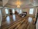 Spacious primary bedroom with hardwood floors, tray ceilings, a chandelier, and multiple windows at 9620 Carolina Dr, Jonesboro, GA 30238