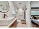 Modern bathroom featuring a glass shower, round mirror, and floating vanity at 2680 Braithwood Ne Rd, Atlanta, GA 30345