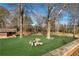 Backyard retreat offers a lovely table set amongst the trees at 4983 Arcado Sw Rd, Lilburn, GA 30047