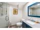 Bathroom with a glass-enclosed shower, toilet, and navy blue vanity with a gray countertop at 4983 Arcado Sw Rd, Lilburn, GA 30047