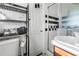 Bathroom featuring a tiled shower and black shelving unit for storage at 4983 Arcado Sw Rd, Lilburn, GA 30047