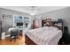 A bedroom featuring a large window, and light-colored walls at 4983 Arcado Sw Rd, Lilburn, GA 30047