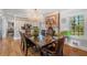 A dining room featuring a large chandelier and windows offering outdoor views at 4983 Arcado Sw Rd, Lilburn, GA 30047