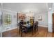 A dining room featuring a large chandelier and windows offering outdoor views at 4983 Arcado Sw Rd, Lilburn, GA 30047