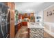A spacious kitchen featuring an island with modern tile, granite countertops, and dark wood cabinetry at 4983 Arcado Sw Rd, Lilburn, GA 30047