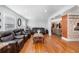 A spacious living room with wood floors and three black leather couches surrounding a marble coffee table at 4983 Arcado Sw Rd, Lilburn, GA 30047