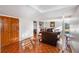 Spacious living room with orange tile flooring, leather sofas, and natural light at 4983 Arcado Sw Rd, Lilburn, GA 30047