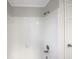 All-white tiled tub and shower combination in a bright bathroom at 5926 Brassie Ridge Ln, Ellenwood, GA 30294