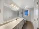Bathroom featuring a long countertop with double sinks, large mirror, and ample lighting at 5926 Brassie Ridge Ln, Ellenwood, GA 30294