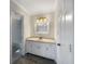 Clean bathroom with a single sink vanity, neutral colors and a door to the shower and toilet area at 5926 Brassie Ridge Ln, Ellenwood, GA 30294
