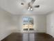 Bright bedroom with hardwood floors, a ceiling fan and a large window to bring in sunlight at 5926 Brassie Ridge Ln, Ellenwood, GA 30294