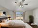 Staged bedroom featuring a comfortable queen bed and serene natural light from the window at 5926 Brassie Ridge Ln, Ellenwood, GA 30294