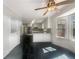 Modern kitchen with white cabinets, stainless steel appliances, stone countertops, and black tile floors at 5926 Brassie Ridge Ln, Ellenwood, GA 30294