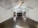 Spacious living room featuring a vaulted ceiling, brick fireplace, and dark hardwood floors at 5926 Brassie Ridge Ln, Ellenwood, GA 30294