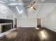 Bright living room featuring hardwood floors, a brick fireplace, skylights, and a ceiling fan at 5926 Brassie Ridge Ln, Ellenwood, GA 30294