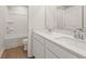 Bright bathroom with a double sink vanity, wood-look floors, and shower-tub combination at 2634 Mourning Dove Drive (Lot 41), Grayson, GA 30017