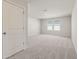 Bright bedroom with neutral carpet, white walls, and a window for natural light at 2634 Mourning Dove Drive (Lot 41), Grayson, GA 30017