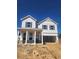 Charming two-story home featuring white siding and an attached two-car garage on a construction site at 2634 Mourning Dove Drive (Lot 41), Grayson, GA 30017