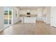 Bright, modern kitchen with an island, stainless appliances, and a sliding glass door leading outside at 2634 Mourning Dove Drive (Lot 41), Grayson, GA 30017