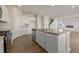 Open concept kitchen with stainless appliances, an island, and a view into the living area with a fireplace at 2634 Mourning Dove Drive (Lot 41), Grayson, GA 30017