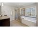 Bathroom with walk-in shower, separate tub, and window at 3610 Ansley Manor Ct, Cumming, GA 30028
