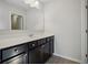 Bathroom vanity features dark wood cabinets, white countertop, undermount sink, and neutral wall color at 3610 Ansley Manor Ct, Cumming, GA 30028