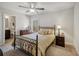 Cozy bedroom with wrought iron bed frame, traditional furniture, and neutral carpet at 3610 Ansley Manor Ct, Cumming, GA 30028