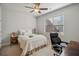 Bright bedroom featuring neutral decor, a ceiling fan, and an adjacent workspace at 3610 Ansley Manor Ct, Cumming, GA 30028
