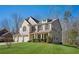 Beautifully landscaped home featuring a three-car garage and a manicured lawn at 3610 Ansley Manor Ct, Cumming, GA 30028