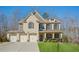 Charming two-story home boasts a well-manicured lawn and a three-car garage at 3610 Ansley Manor Ct, Cumming, GA 30028