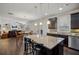 Gourmet kitchen boasts dark cabinets, granite counters, stainless appliances, and island seating at 3610 Ansley Manor Ct, Cumming, GA 30028