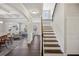 Open living area with hardwood floors, staircase, and combined living spaces at 3610 Ansley Manor Ct, Cumming, GA 30028