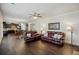 Open living room showcasing hardwood floors and comfortable leather furniture with adjacent kitchen at 3610 Ansley Manor Ct, Cumming, GA 30028