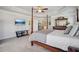 Main bedroom with tray ceiling, four poster bed, and dark wood furniture at 3610 Ansley Manor Ct, Cumming, GA 30028